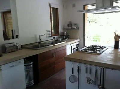 a kitchen with a sink and a stove top oven at meiji in Pinarellu
