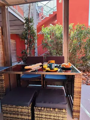 a table and chairs with a plate of food on it at T2 Cyprien, Climatisé, piscines, resto, Plages 2-4 pers in Lecci