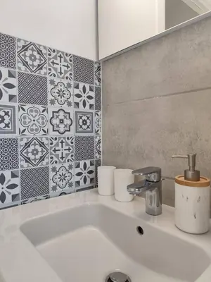 a white sink in a bathroom with tiles at T2 Cyprien, Climatisé, piscines, resto, Plages 2-4 pers in Lecci