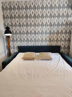 a bedroom with a bed with two pillows on it at T2 Cyprien, Climatisé, piscines, resto, Plages 2-4 pers in Lecci