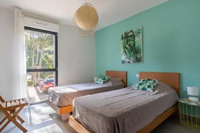 a bedroom with two beds and a window at La Plage d'Argent - Vue mer et montagne in Coti-Chiavari