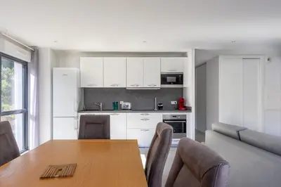 a kitchen and dining room with a table and chairs at La Plage d'Argent - Vue mer et montagne in Coti-Chiavari