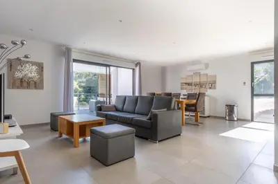 a living room with a couch and a table at La Plage d'Argent - Vue mer et montagne in Coti-Chiavari