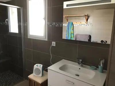 a bathroom with a sink and a mirror at Accès Direct Mer, Commerces Rivière 15mn in Santa-Lucia-di-Moriani