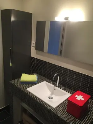 a bathroom counter with a sink and a mirror at Location appartement de vacances Ajaccio in Ajaccio