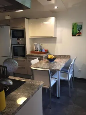 a kitchen with a table with a bowl of fruit on it at Location appartement de vacances Ajaccio in Ajaccio