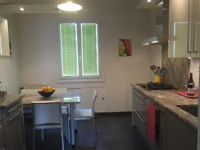 a kitchen with a counter and a table with chairs at Location appartement de vacances Ajaccio in Ajaccio