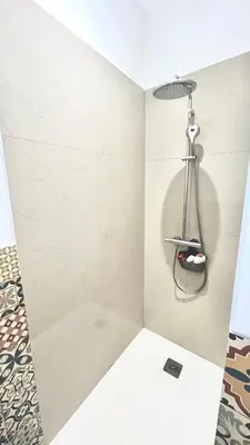a bathroom with a shower with a shower head at havre de paix à Pianottoli proche des plages in Pianottoli-Caldarello