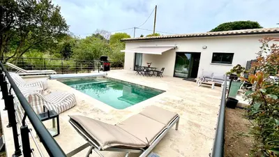 a swimming pool with chairs and a house at havre de paix à Pianottoli proche des plages in Pianottoli-Caldarello