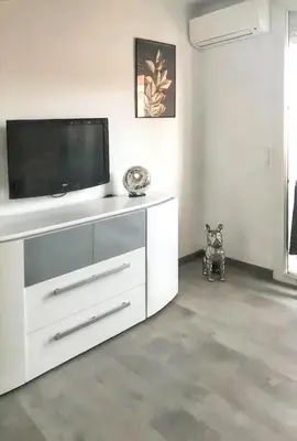 a white entertainment center with a tv on top of it at Appartement à Ajaccio avec vue sur la mer in Ajaccio