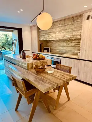 a wooden table with chairs around it on a patio at Villa Mamma in Zonza