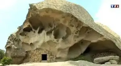 a large rock structure with a small window in it at Gîte Ortolu in Monacia-dʼAullène