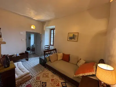 a living room with a couch and a table at Maison de Caractère au coeur du village in Castifao