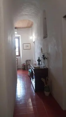 a living room with a tile floor and a fireplace at Maison de Caractère au coeur du village in Castifao