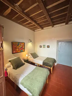 a room with two beds in a room at Maison de Caractère au coeur du village in Castifao