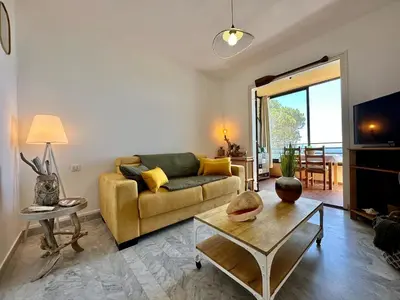 a living room with a couch and a table at Studio vue mer in Ajaccio