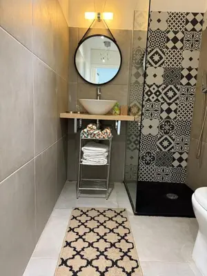 a bathroom with a sink and a mirror at Loft Place du Diamant Hyper centre ville Plage 50m in Ajaccio