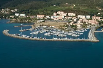an aerial view of a harbor with boats in the water at Le Thyreneen in Sari Solenzara