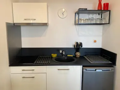a small kitchen with a sink and a stove at Helios grand studio terrasse panoramique magique in Ajaccio