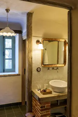 a bathroom with a sink and a mirror at A Mandria di Murtoli in Sartène