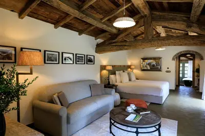 a living room with a bed and a couch at A Mandria di Murtoli in Sartène