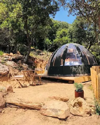 a black dome tent sitting in the dirt at Palom'bolla in Porto-Vecchio