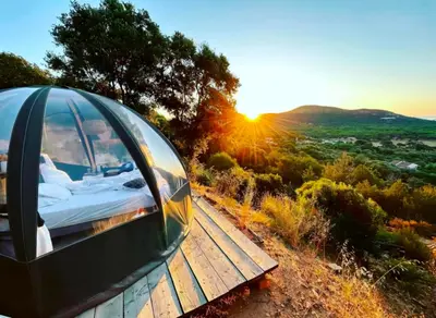 a iguana tent on a wooden deck with the sunset at Palom'bolla in Porto-Vecchio