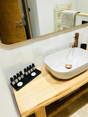 a bathroom with a white sink and a mirror at Stone Sheepfold With Sea View In Corsica in Sari-dʼOrcino