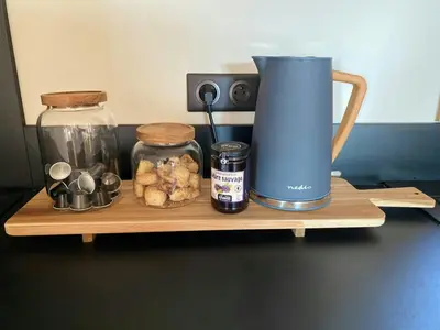 a wooden shelf with a blender and jars of food at Stone Sheepfold With Sea View In Corsica in Sari-dʼOrcino
