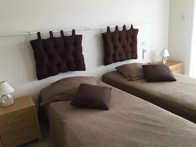 a bedroom with two beds and a headboard at Locations I Carboni - villa 2 chambres in Sollacaro
