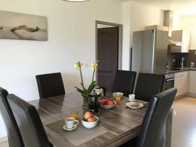 a dining room with a table and chairs with fruit on it at Locations I Carboni - villa 2 chambres in Sollacaro