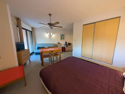 a bedroom with a bed and a dining room at Au Châtaignier Corse in Vico