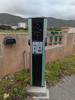a parking meter sitting on the side of a wall at Au Châtaignier Corse in Vico