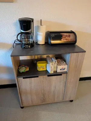 a shelf with a coffee maker on top of it at Au Châtaignier Corse in Vico