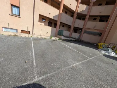 an empty parking lot in front of a building at Au Châtaignier Corse in Vico