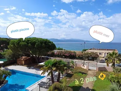 a view of a pool and the ocean with two speech bubbles at Au Châtaignier Corse in Vico