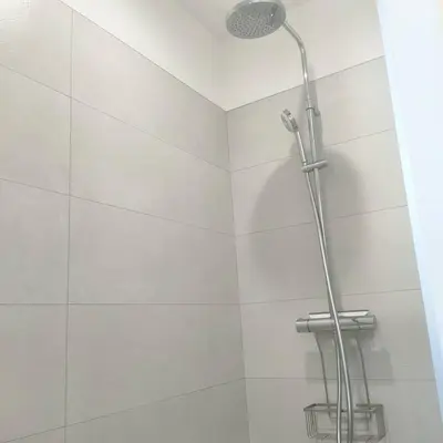 a shower stall with a shower head in a bathroom at suara in Pinarellu