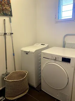 a laundry room with a washing machine and a basket at t3cj n14 in Pinarellu