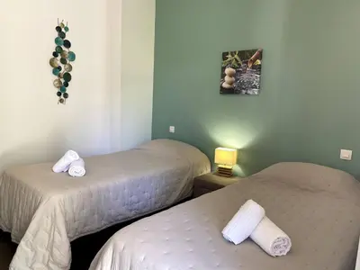 a room with two beds with towels on them at t3cj n14 in Pinarellu