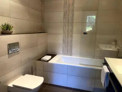 a bathroom with a tub and a toilet and a sink at t3cj n14 in Pinarellu