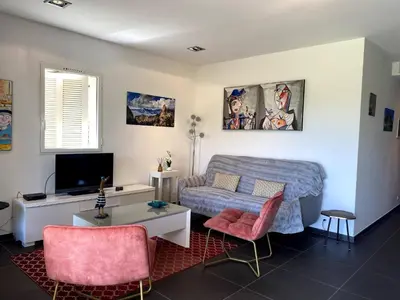 a living room with a bed and a tv at t3cj n14 in Pinarellu