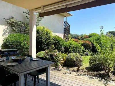 a wooden table and chairs on a patio at t3cj n14 in Pinarellu