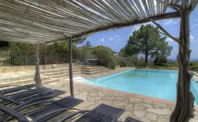 a patio with chairs and a swimming pool at A Machja 16 in Monacia-dʼAullène