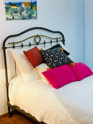 a bed with colorful pillows on top of it at Ajaccio sanguinaires F3 in Ajaccio