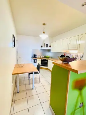 a kitchen with white cabinets and a green counter top at Ajaccio sanguinaires F3 in Ajaccio
