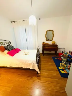 a bedroom with a bed and a mirror and a table at Ajaccio sanguinaires F3 in Ajaccio