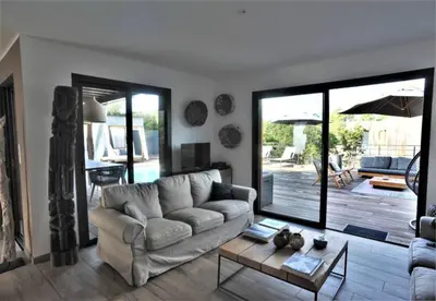 a living room with a couch and a table at alcudina in Zonza