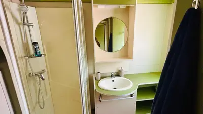 a bathroom with a sink and a mirror at Chalet A tout confort à deux pas des plages in Pianottoli-Caldarello