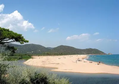 a beach with people on the sand and the water at Un cocon de détente entre mer et nature in Zonza