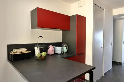 a kitchen with a counter top with a pink appliance at Acula Marina - Mer, Maquis Corse - T4 Lumineux in Ajaccio